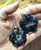 Carved Black Agate Flower Pendant, Sterling Silver Necklace - human hand for scale