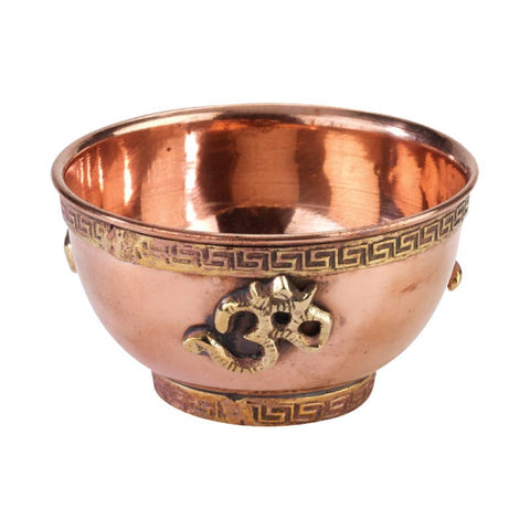 Copper bowl with decorative patterns on a white background