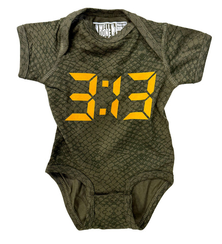 An olive green short-sleeve baby bodysuit with a reptile-scale pattern and a large yellow digital clock graphic reading '3:13' on the front.