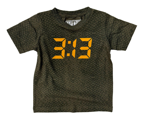 A short-sleeve crewneck t-shirt in olive green with a subtle reptile or snakeskin pattern, featuring a large orange digital clock face graphic on the chest displaying '3:13'.