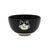 A black porcelain bowl featuring a cute white line art illustration of a cat's face on the front, set against a plain white background. 