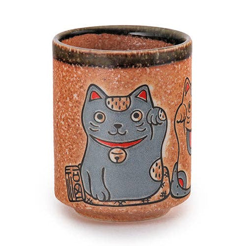 Porcelain Yunomi style tea cup in a copper color with two japanese lucky cats side by side waving. Cup is on a white background. 