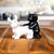 Black and white ceramic dog-shaped salt and pepper shakers on a wooden table.