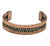 A copper cuff bracelet with a textured woven brass running horizontally across the center.