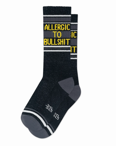 Black and grey crew cut socks that read "Allergic To Bullshit" on the ankle.