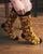 Person wearing mustard yellow socks with black text on a wooden floor. Text  on socks reads "Have a nice fucking day."
