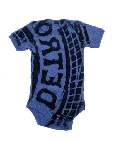 Detroit Tire manhole in black printed on blue baby oneise