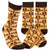 Two socks with a leaf pattern and text on a white background. Text  on socks reads "Have a nice fucking day."