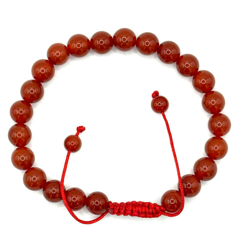 A beaded bracelet made of polished reddish-brown round beads with a red cord closure and a small red accent bead, shown on a plain white background.