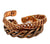 A stack of copper bracelets in three styles, including braided and twisted patterns, shown on a plain white background.
