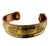 A wide cuff bracelet made of mixed metals, featuring a central gold-toned band engraved with buddha statues, flanked by a silver-toned band and a warm bronze-toned outer band, shown on a plain white background.
