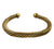 A twisted open cuff bracelet made of metallic gold, bronze, and copper-colored wire, shown on a plain white background.