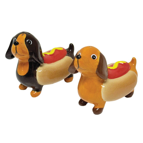 Two dog-shaped hot dogs with mustard on a white background