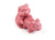 Two pink ceramic pigs in a suggestive position on a white background. 