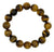 A beaded stretch bracelet made of polished round tiger's eye beads with a natural brown and black banded pattern, displayed on a clean white background.