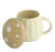 A cream-colored ceramic mug with a matching lid featuring white polka dots, set against a plain white background.