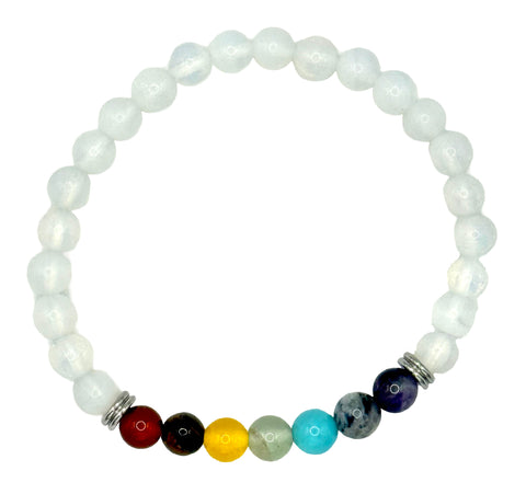 A beaded stretch bracelet featuring white pearl-like round beads and a row of seven colorful gemstone beads at the bottom, separated by small silver spacer beads, on a plain white background.