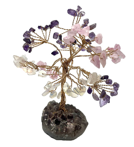 Crystal tree with chips of amethyst, opalite and rose quartz on a base made of raw amethyst . 