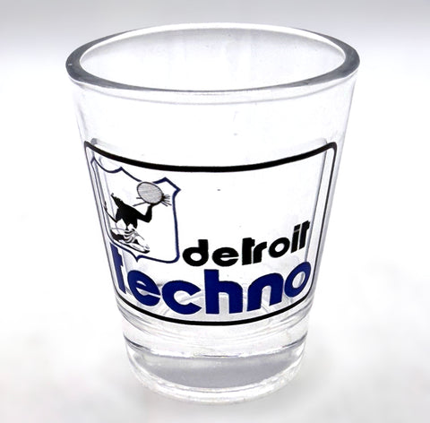 Clear glass shot glass with "Detroit Techno" DPD logo parody on a white background